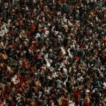 a large group of people standing in a stadium