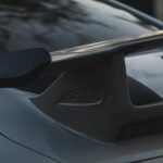 a close up of a car with a surfboard on the roof